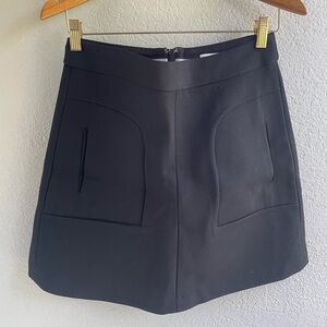 Maeve black mini skirt with front pockets